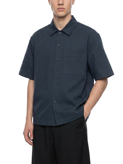 Unisex Resist 100% Cotton Oversized Drop-Shoulder Short Sleeve Shirt With Patch Pocket, dark blue front view on a model with button-down collar and chest pocket